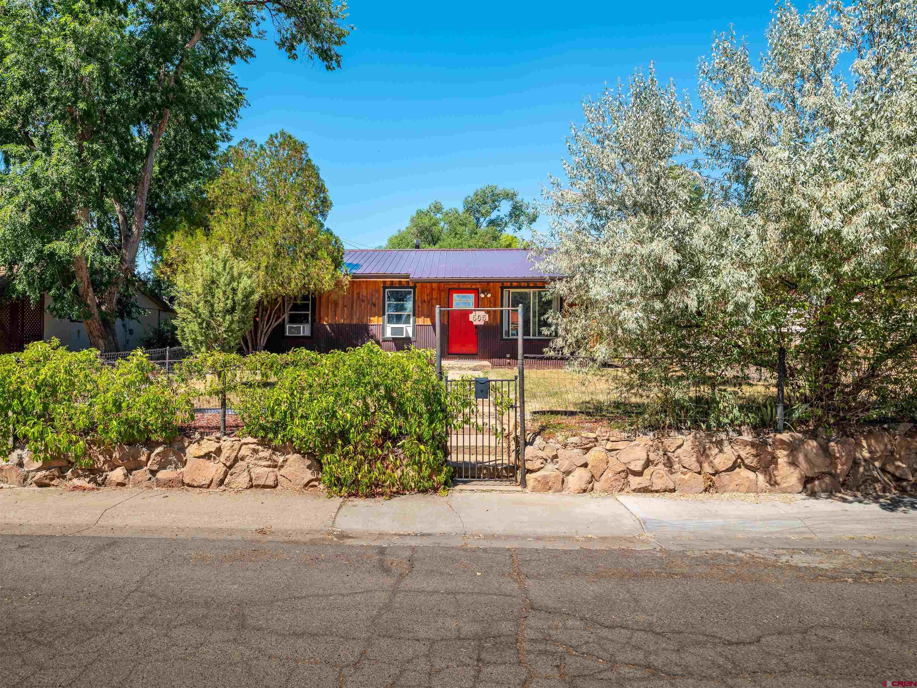 505 South Valley Road Cortez, CO 81321 - Photo 3 of 27 a front view of a house with a yard