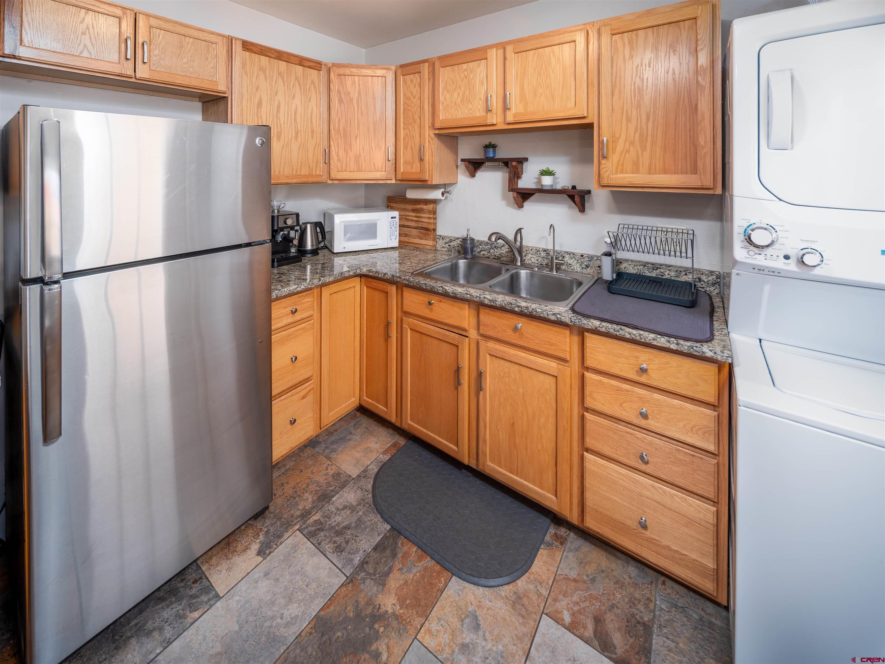 505 South Valley Road Cortez, CO 81321 - Photo 10 of 27 a kitchen with granite countertop a refrigerator and a sink