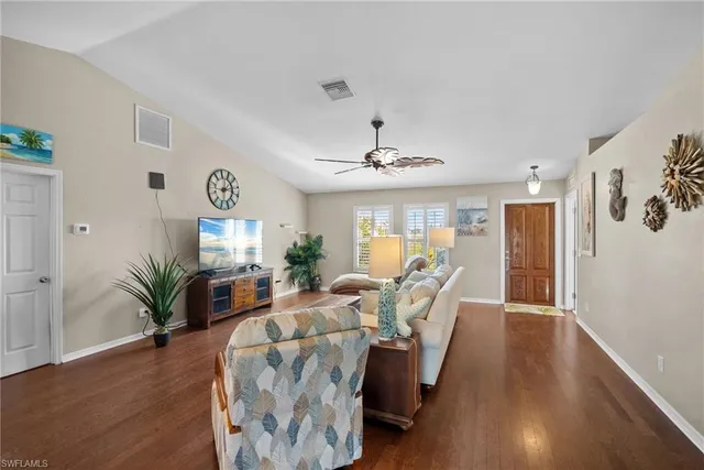 a living room with furniture potted plant and a window