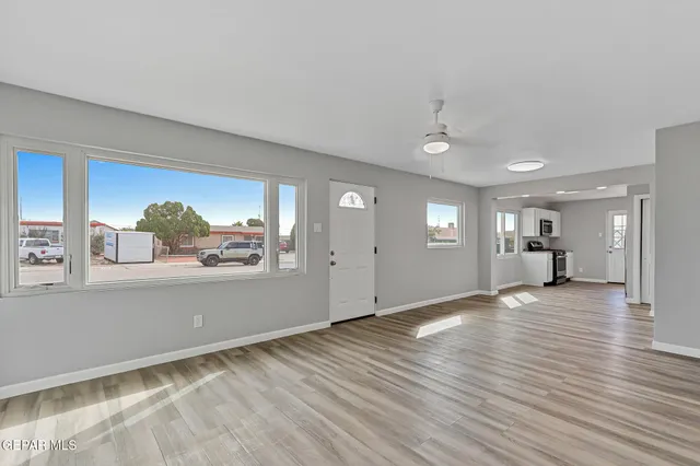 a view of an empty room and wooden floor