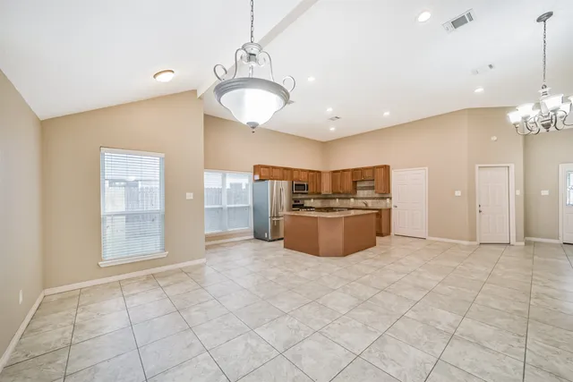 a kitchen with stainless steel appliances granite countertop a stove and a refrigerator