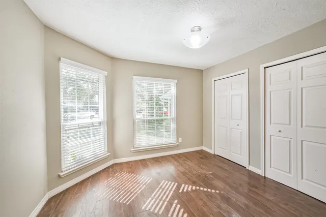 a bathroom with a granite countertop sink a toilet and shower