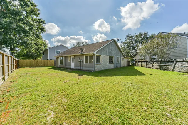 a yellow house with trees in front of it