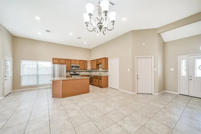 a kitchen with stainless steel appliances granite countertop a refrigerator and a sink
