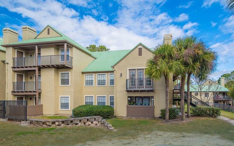249 Afton Square, Unit 111 Altamonte Springs, FL 32714 - Photo 1 of 1 a front view of a house with a garden