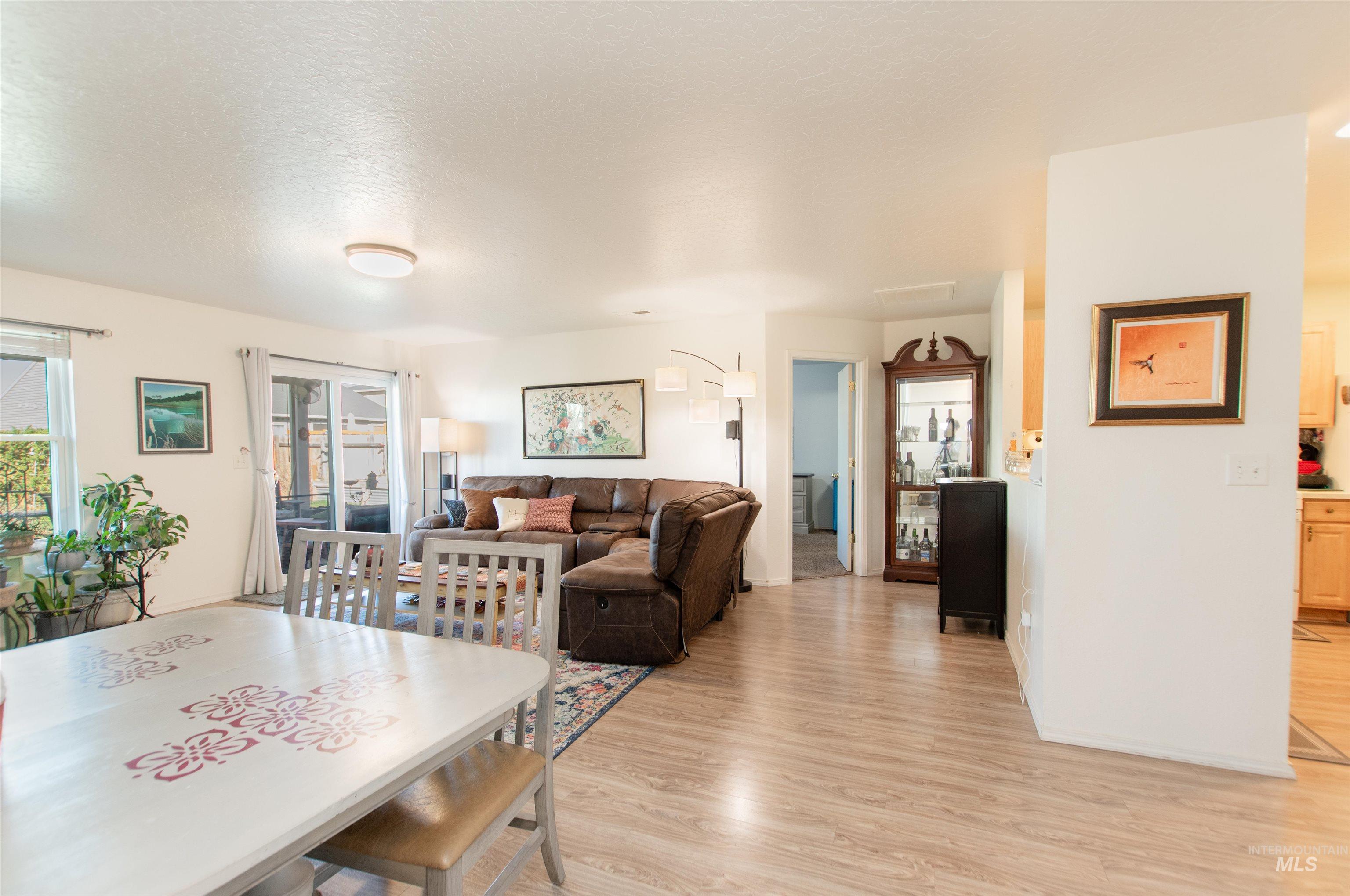 16711 Abram Avenue Caldwell, ID 83607 - Photo 11 of 24 Dining room featuring light wood-type flooring and a textured ceiling