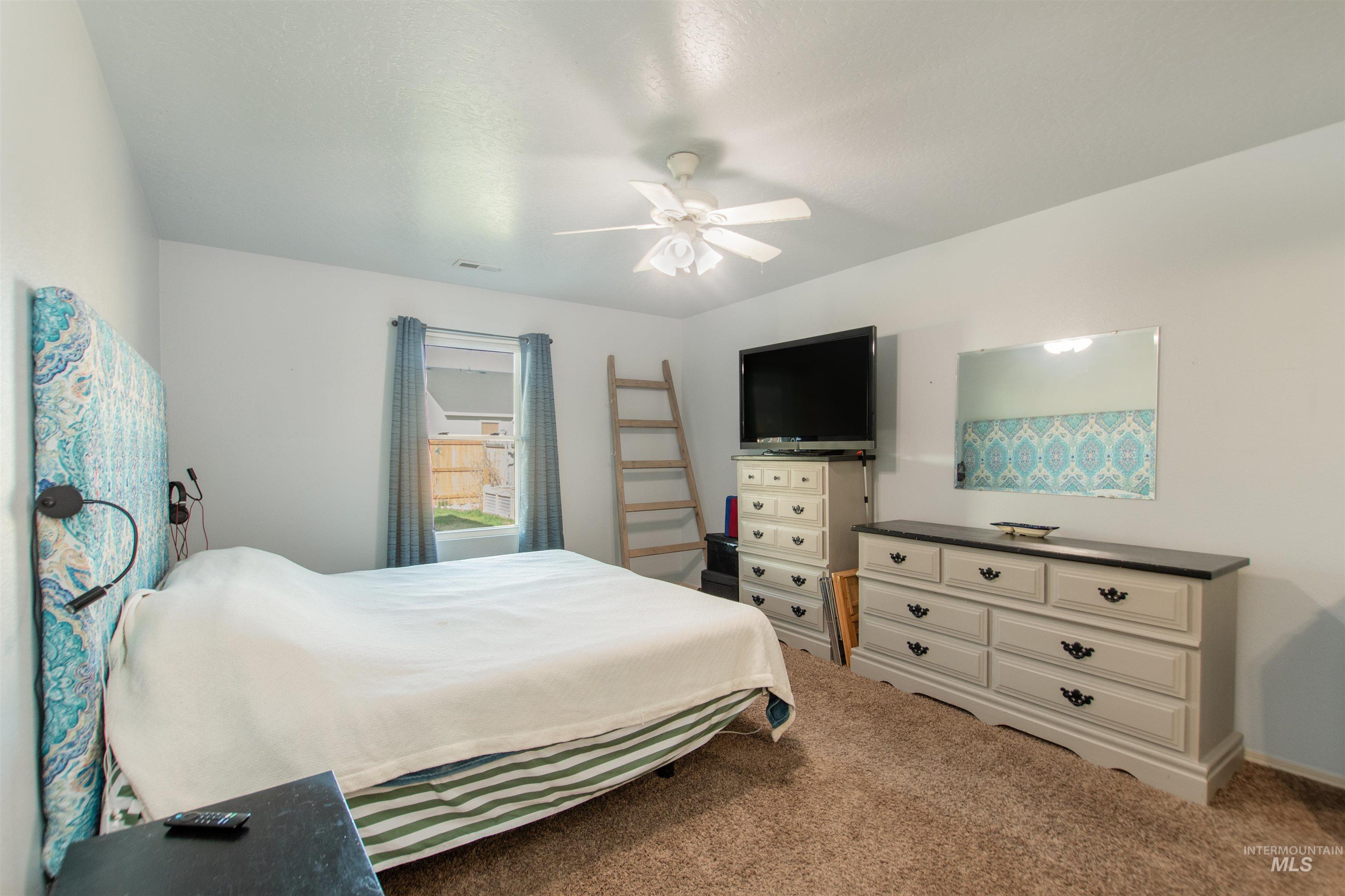 16711 Abram Avenue Caldwell, ID 83607 - Photo 12 of 24 Carpeted bedroom featuring ceiling fan