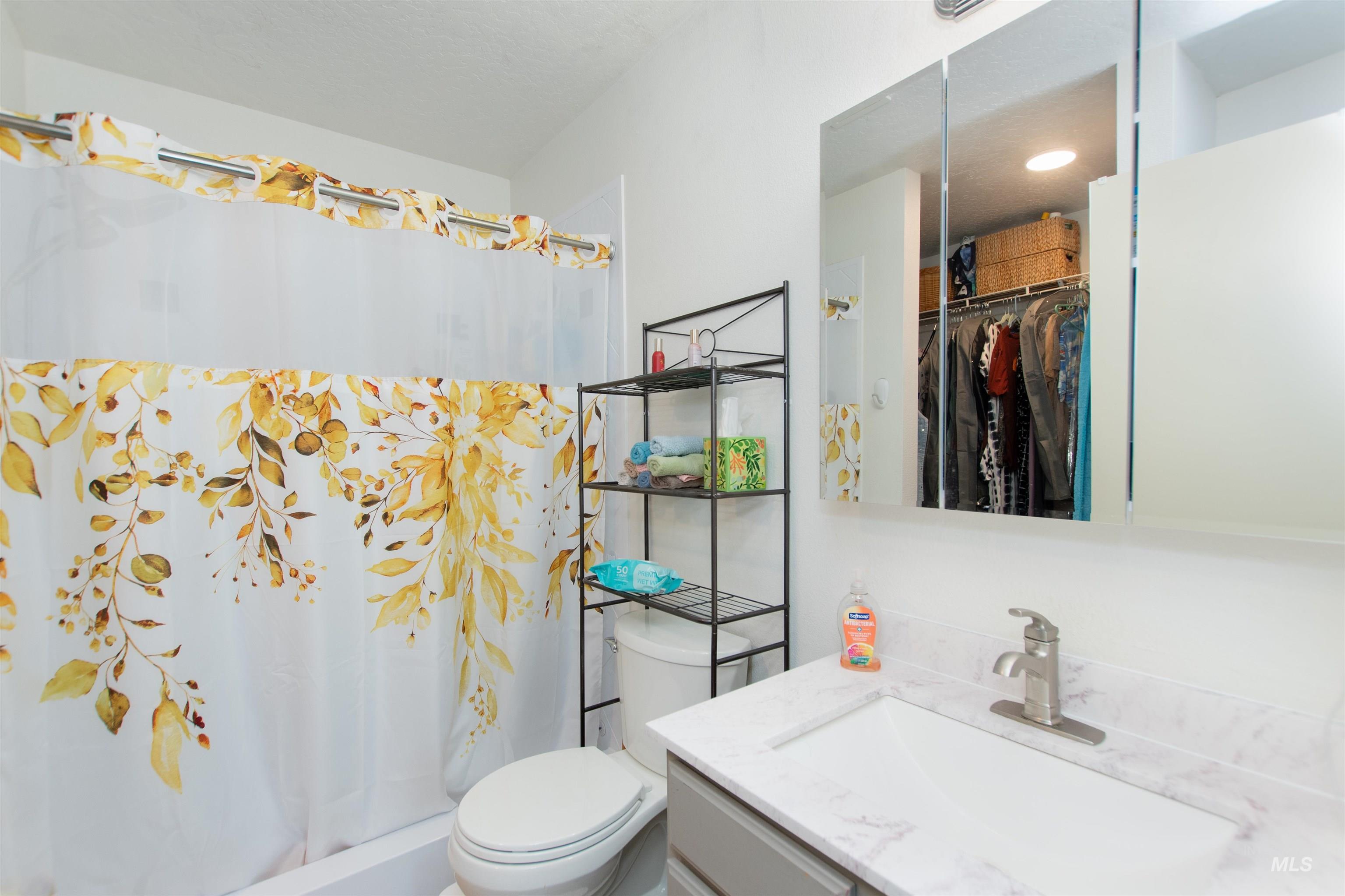 16711 Abram Avenue Caldwell, ID 83607 - Photo 14 of 24 Full bath with vanity, a shower with shower curtain, and a walk in closet