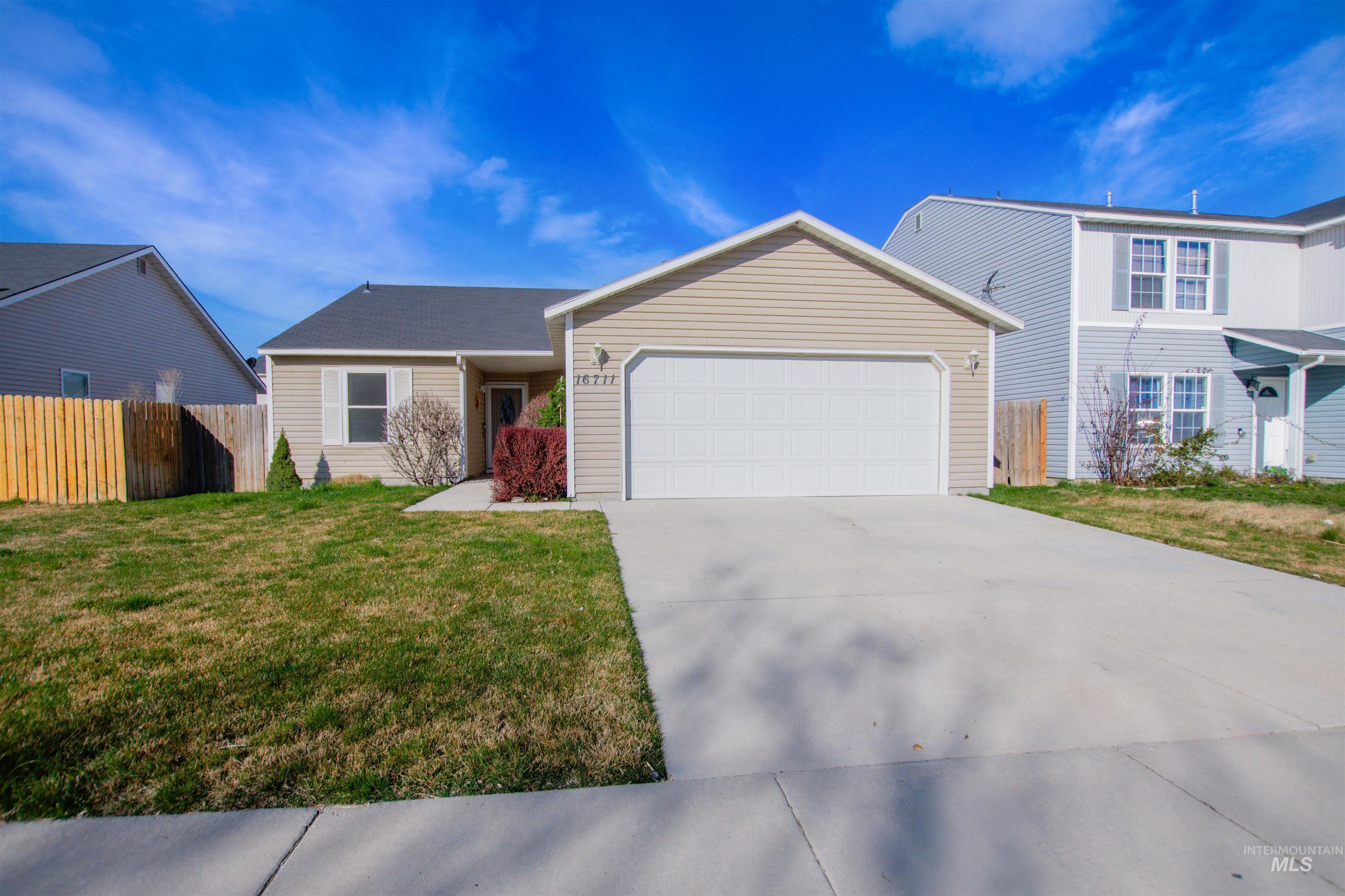 16711 Abram Avenue Caldwell, ID 83607 - Photo 2 of 24 View of front of home with a garage and driveway
