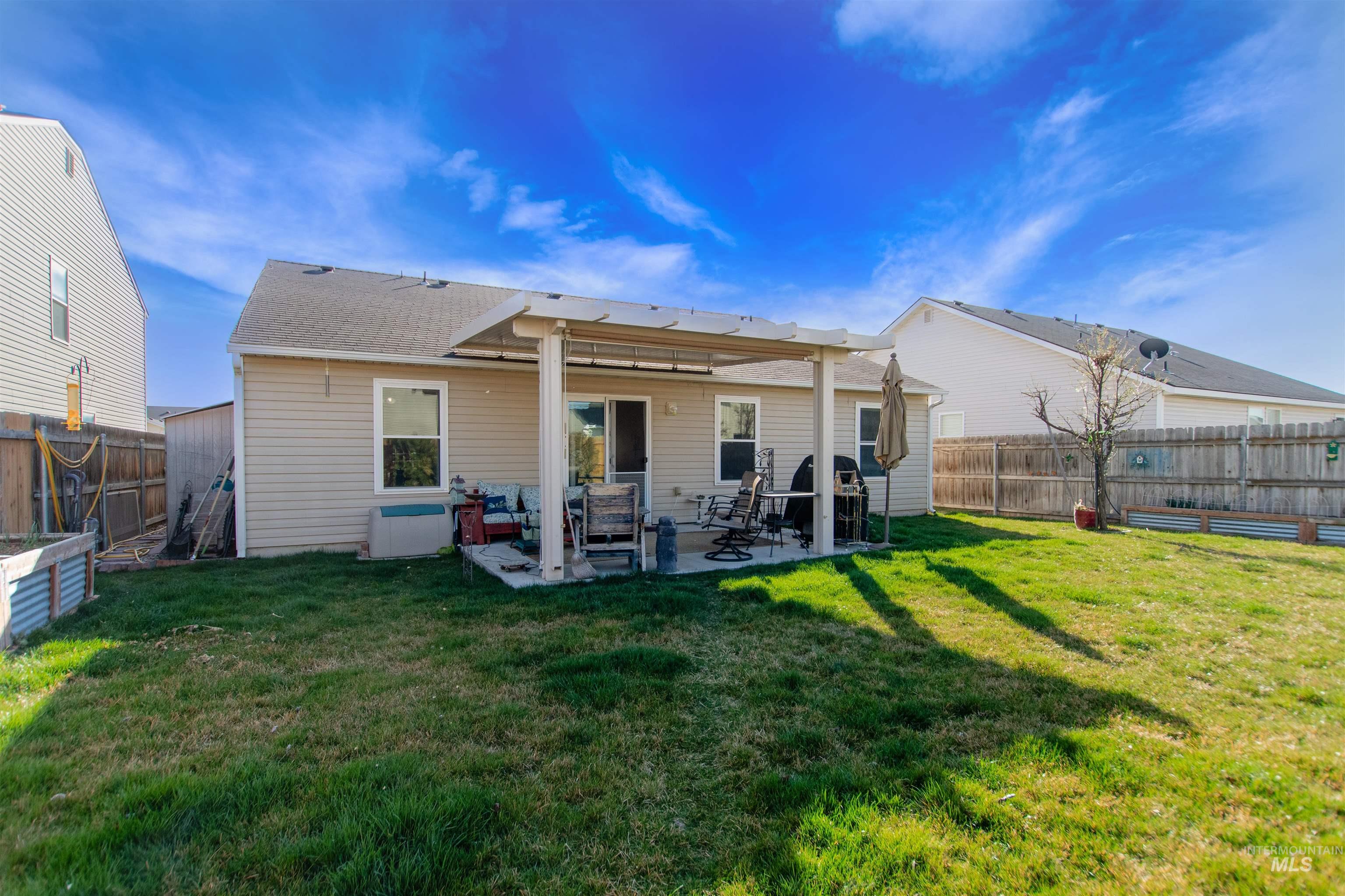 16711 Abram Avenue Caldwell, ID 83607 - Photo 21 of 24 Back of property featuring a patio and a fenced backyard