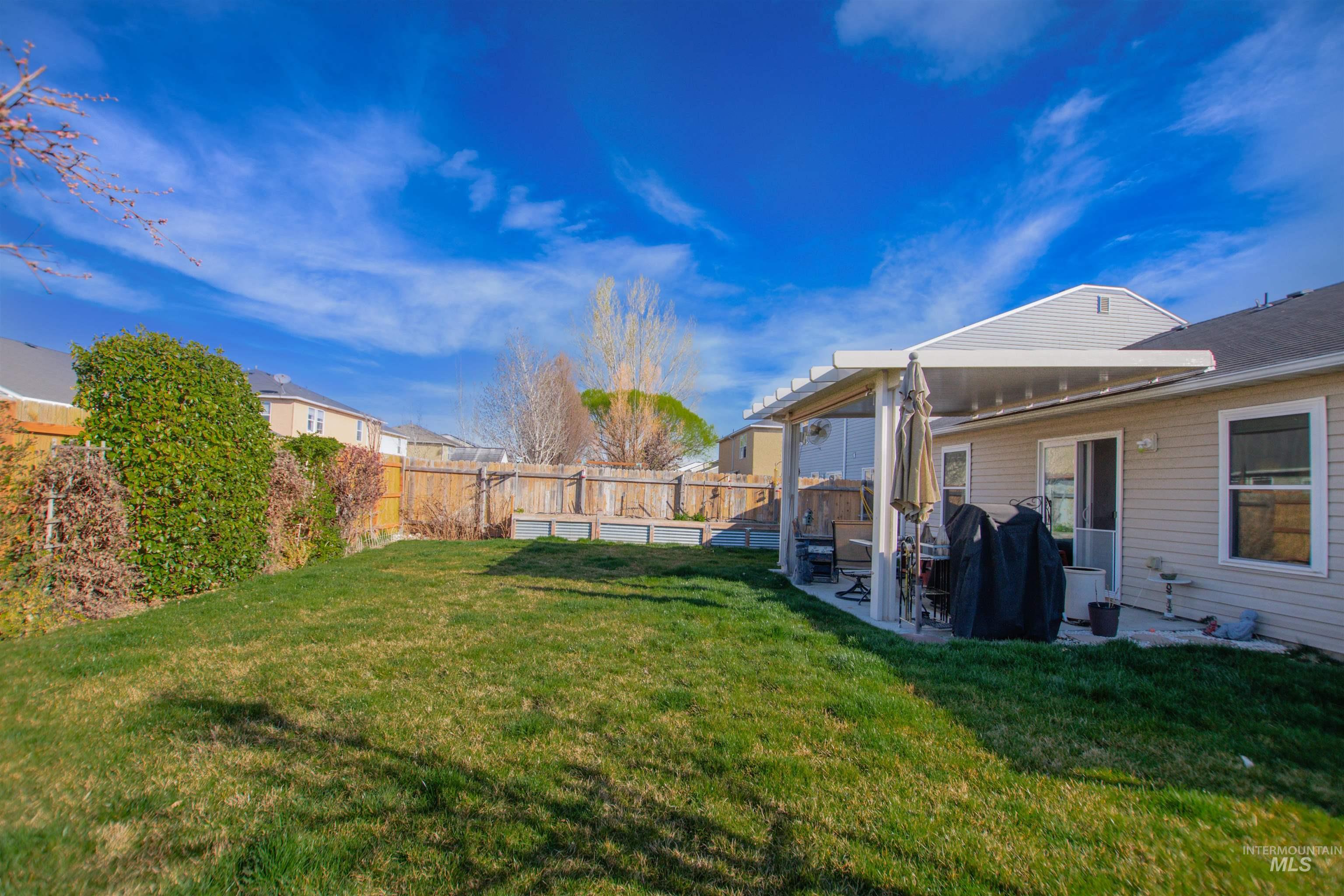 16711 Abram Avenue Caldwell, ID 83607 - Photo 23 of 24 Fenced backyard with a patio