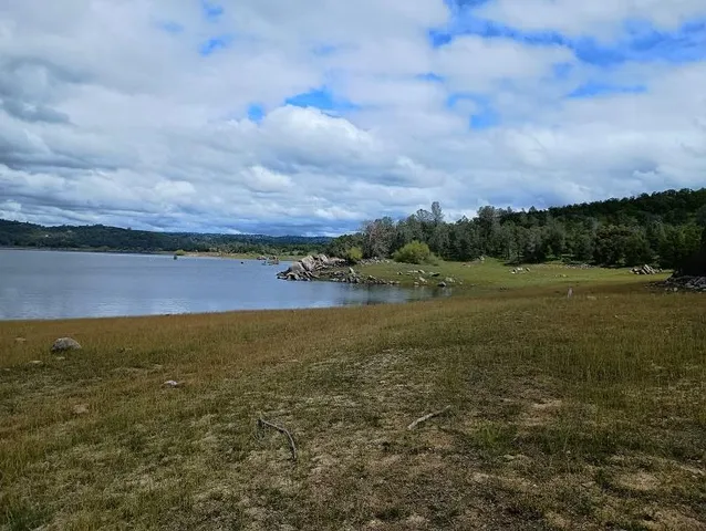 a view of a lake with houses in the back