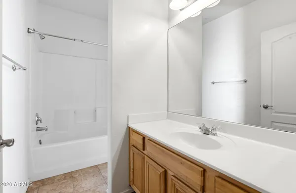 a bathroom with a sink double vanity granite tub shower and a mirror