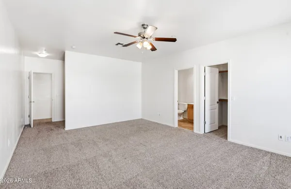 a view of empty room with ceiling fan