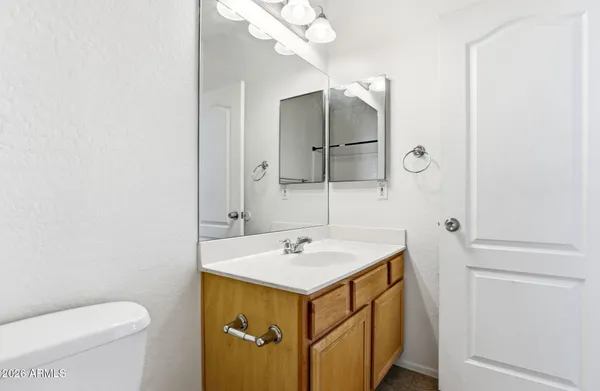 a bathroom with a sink a toilet and a mirror
