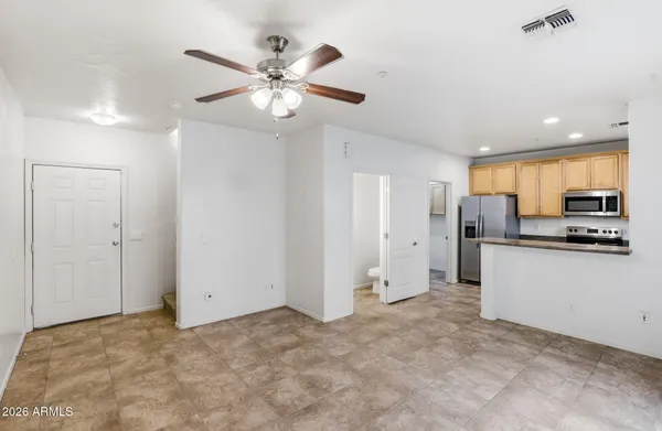 a view of a kitchen with a sink and stainless steel appliances
