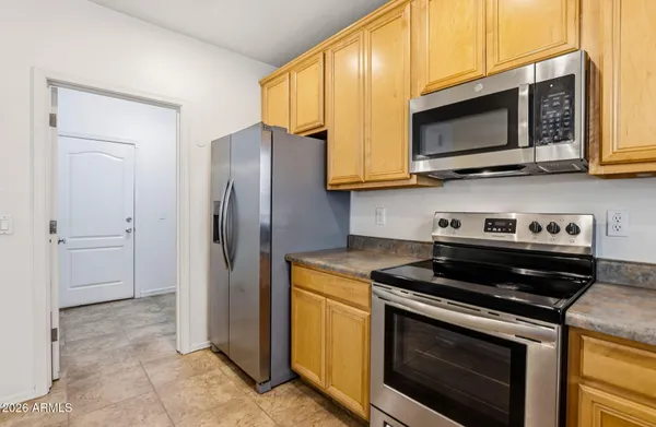 a kitchen with stainless steel appliances granite countertop a stove microwave and refrigerator