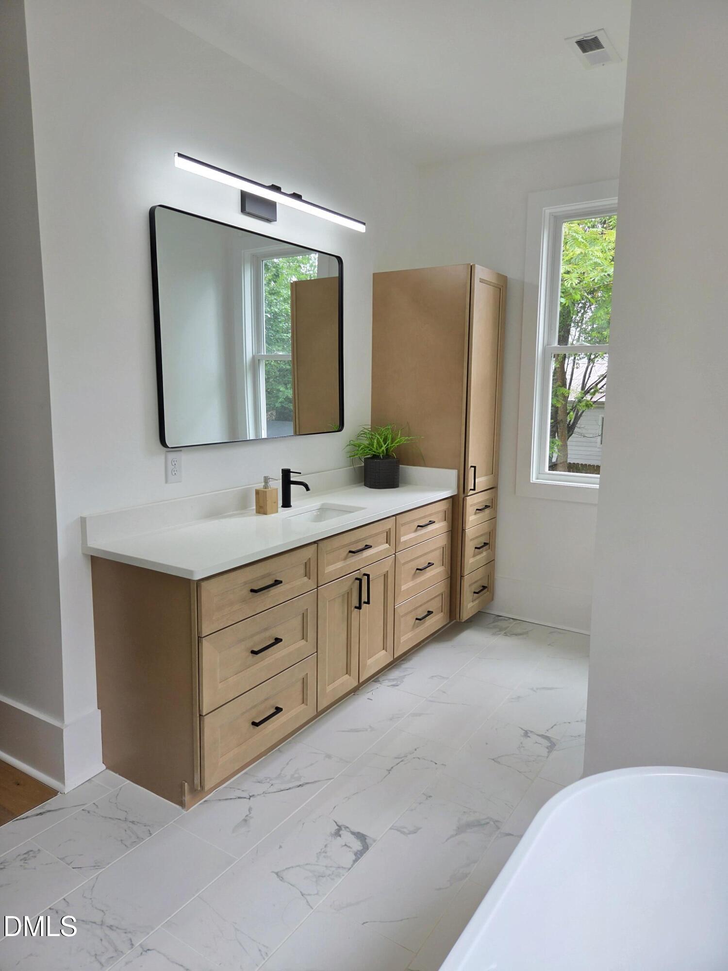 712 Van Buren Road Raleigh, NC 27604 - Photo 13 of 34 a bathroom with a double vanity sink and mirror