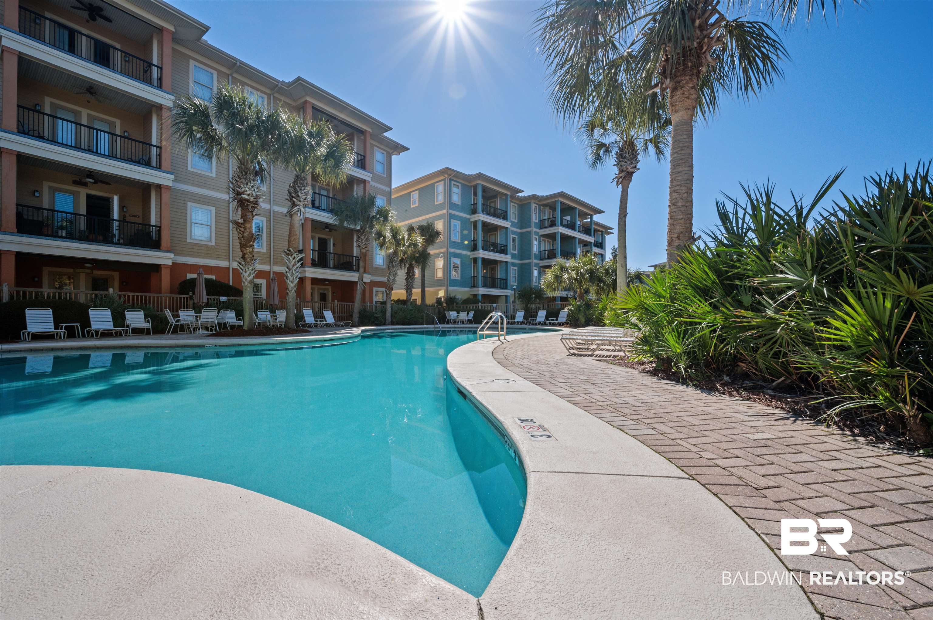1430 Regency Road, Unit B202 Gulf Shores, AL 36542 - Photo 31 of 33 Community pool featuring a ceiling fan, fence, and a patio
