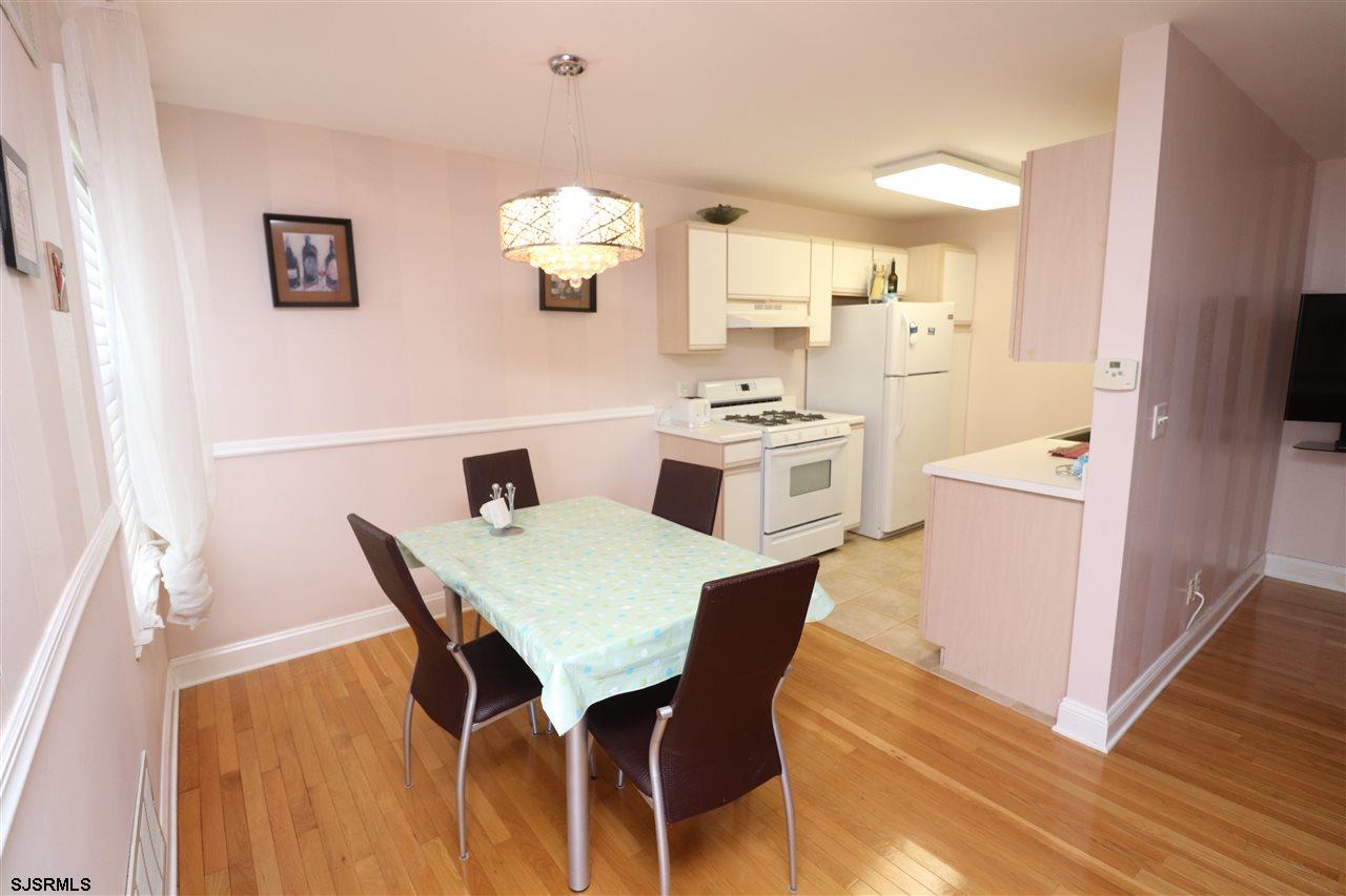 200 North Decatur Avenue, Unit 1 Margate City, NJ 08402 - Photo 4 of 12 a view of a dining room with furniture and wooden floor