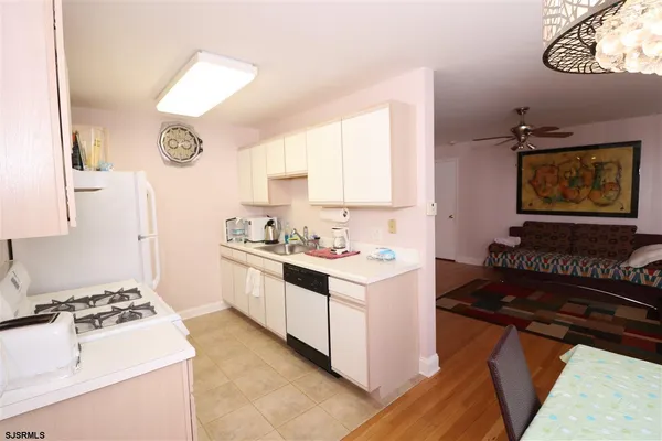a kitchen with a stove a sink and a refrigerator