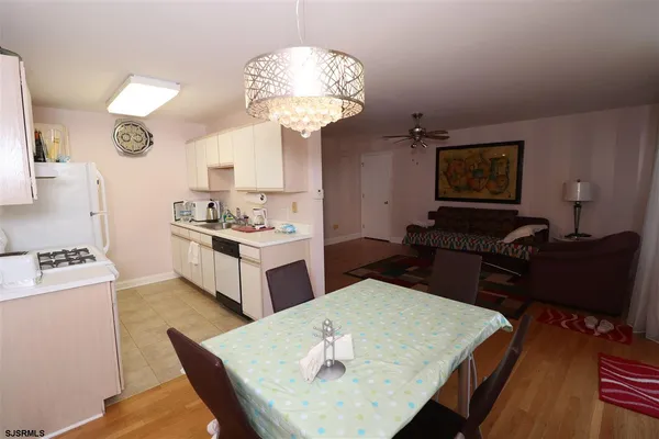 a living room with kitchen island furniture and a chandelier