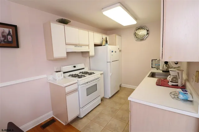 a kitchen with a stove and a refrigerator