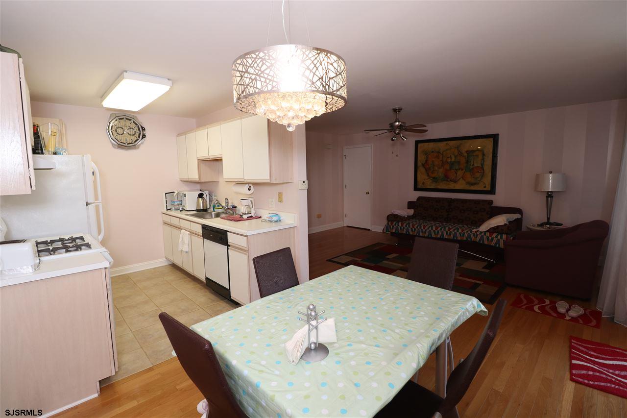 200 North Decatur Avenue, Unit 1 Margate City, NJ 08402 - Photo 8 of 12 a living room with kitchen island furniture and a chandelier