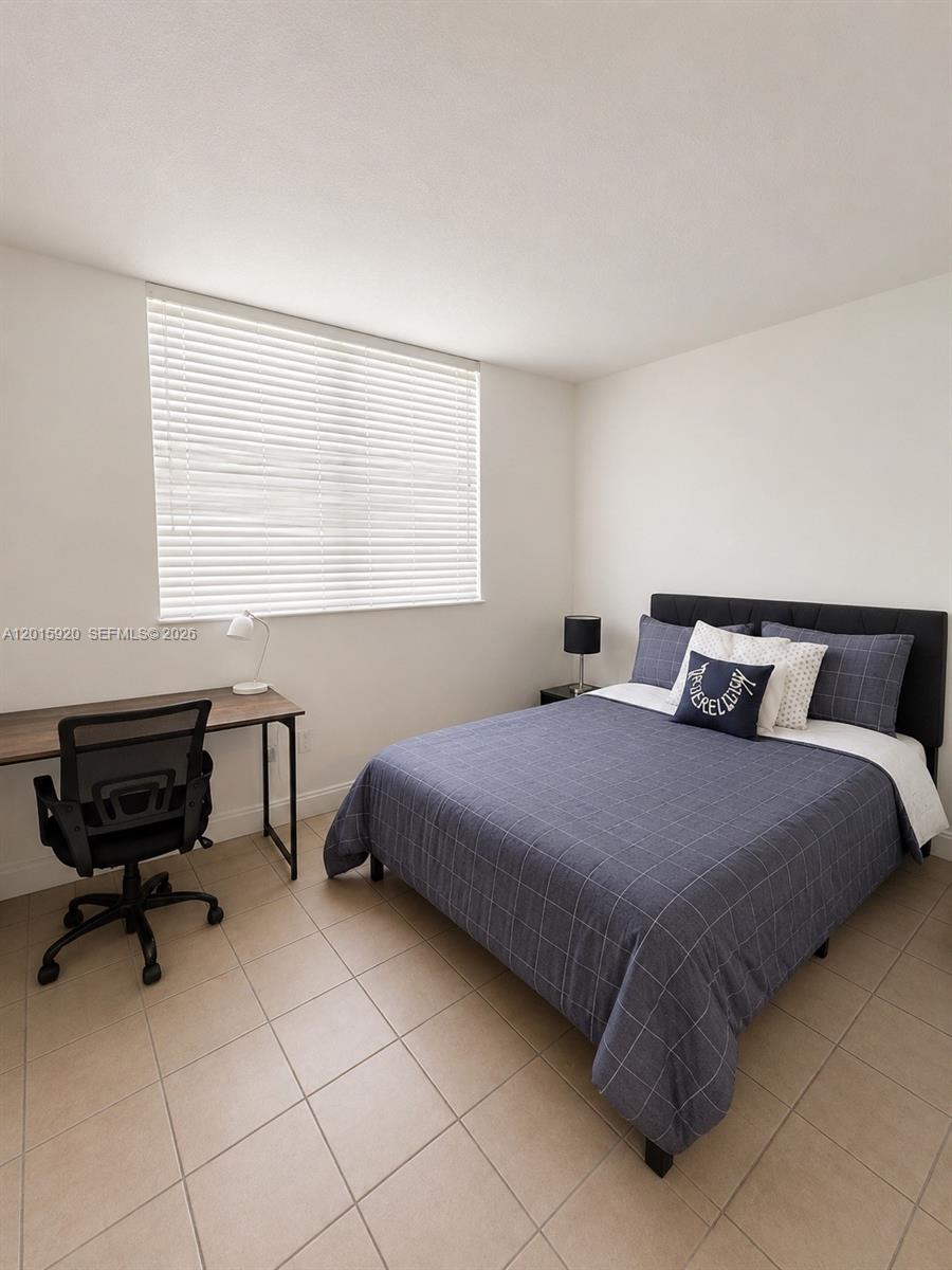 14170 Southwest 84th Street, Unit 404F Miami, FL 33183 - Photo 10 of 18 a bedroom with a bed and a window