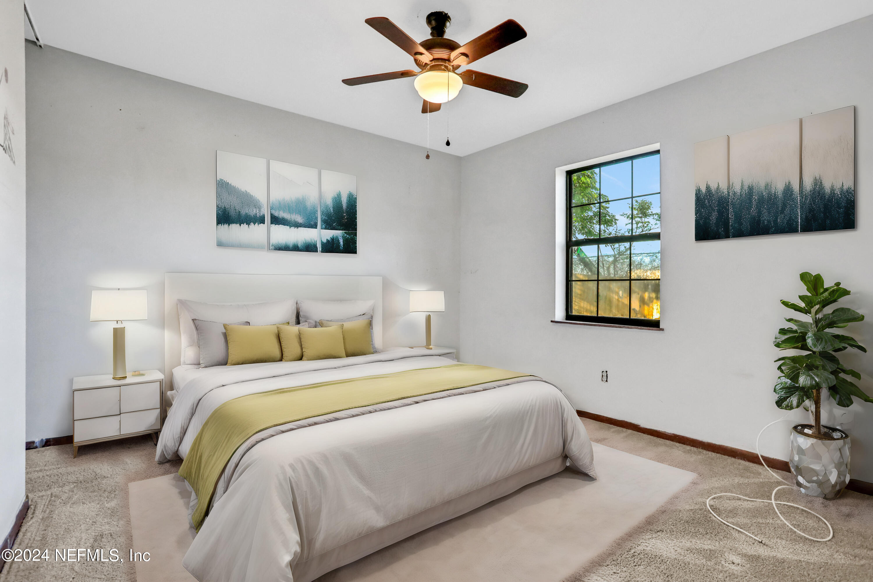 230 Cornell Road St. Augustine, FL 32086 - Photo 12 of 32 a bedroom with a bed and a potted plant