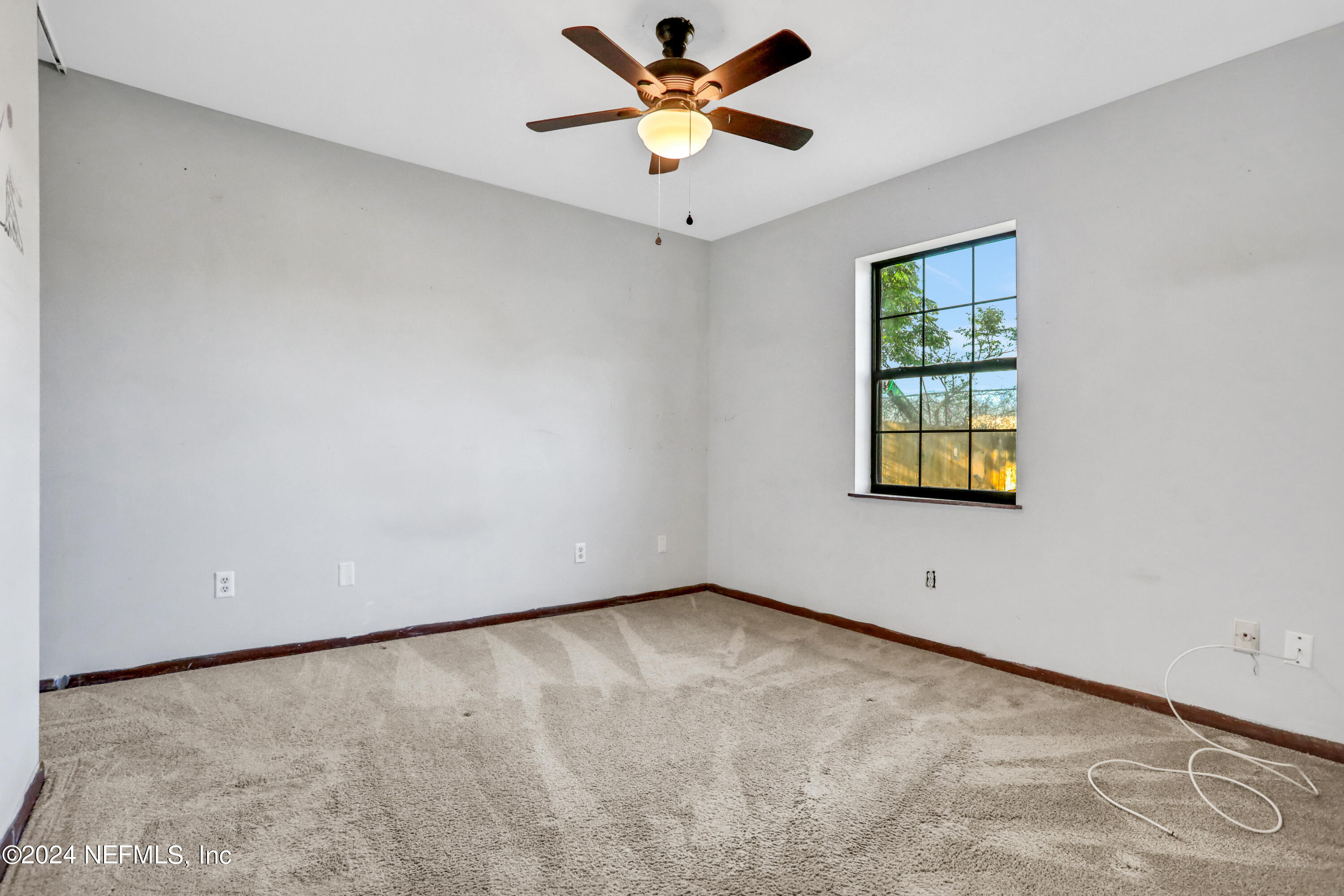 230 Cornell Road St. Augustine, FL 32086 - Photo 13 of 32 an empty room with a window and a ceiling fan
