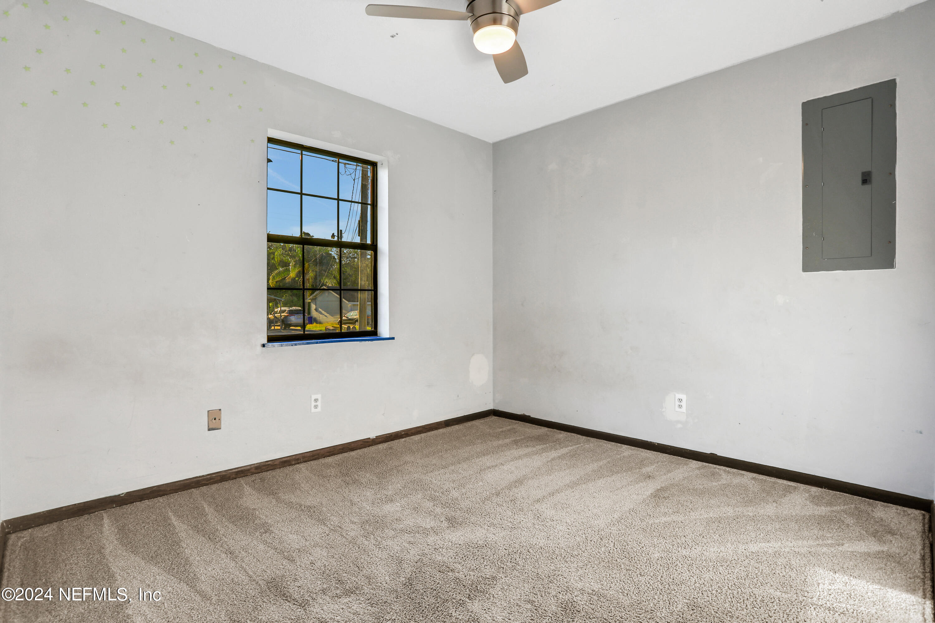 230 Cornell Road St. Augustine, FL 32086 - Photo 15 of 32 an empty room with a window and a ceiling fan