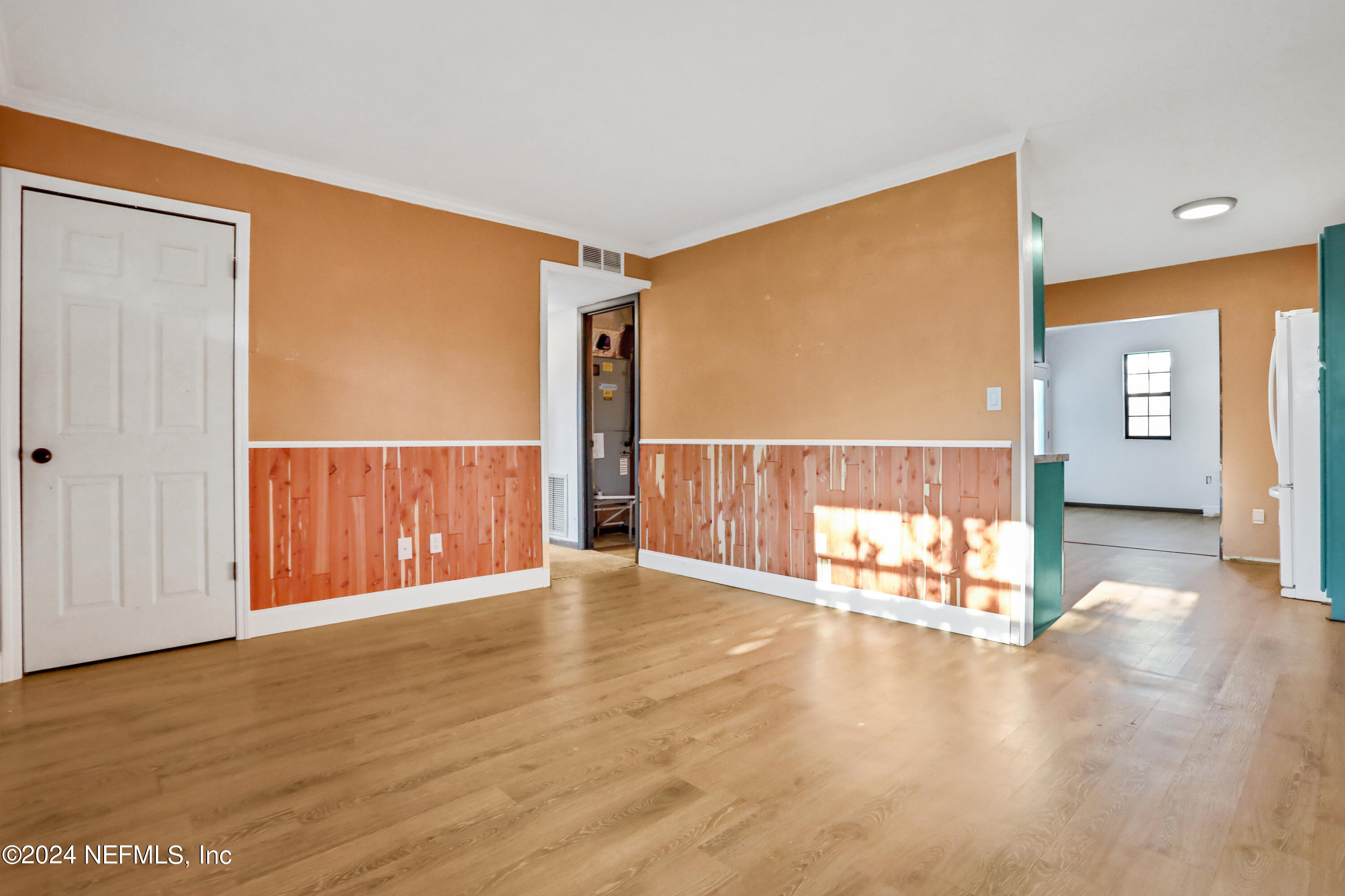 230 Cornell Road St. Augustine, FL 32086 - Photo 10 of 32 a view of an empty room with wooden floor and a window