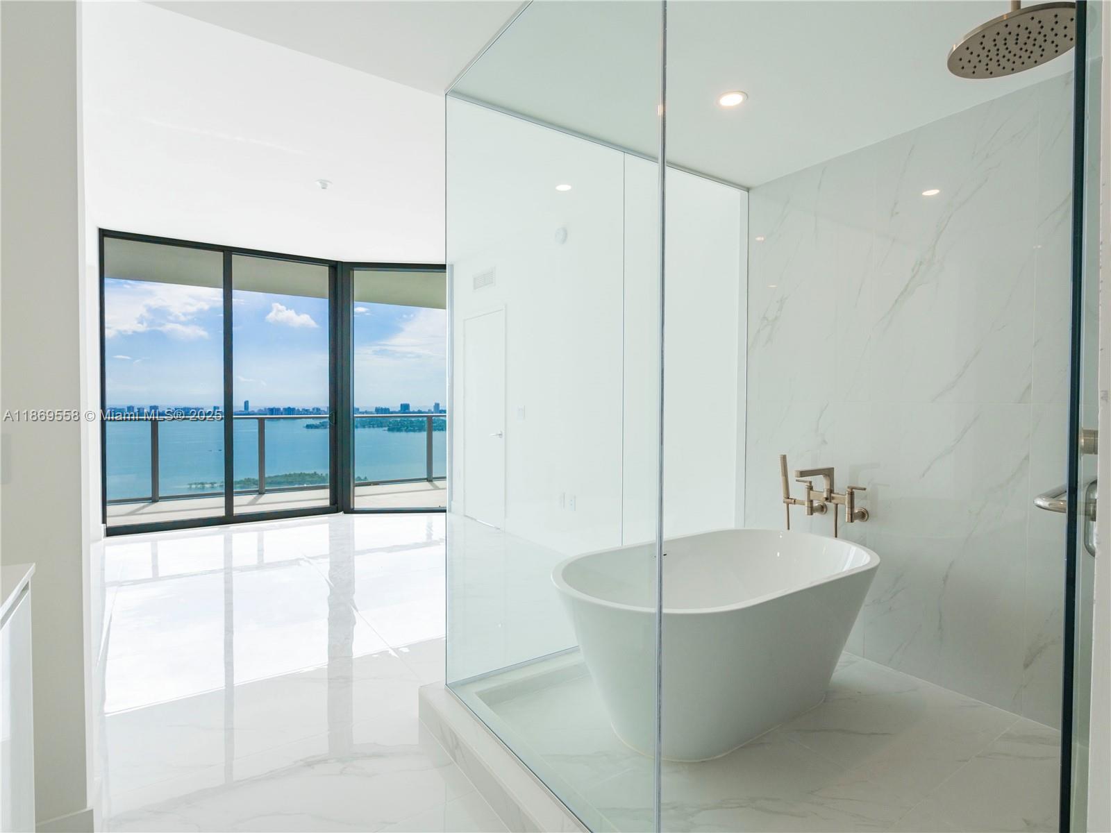 700 Northeast 24th Street, Unit 3606 Miami, FL 33137 - Photo 11 of 28 a bathroom with a bathtub and shower