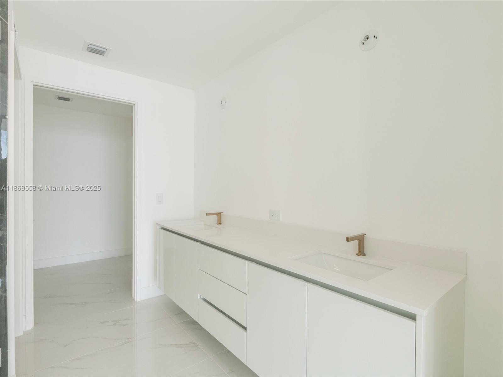 700 Northeast 24th Street, Unit 3606 Miami, FL 33137 - Photo 13 of 28 a room with a sink and a mirror