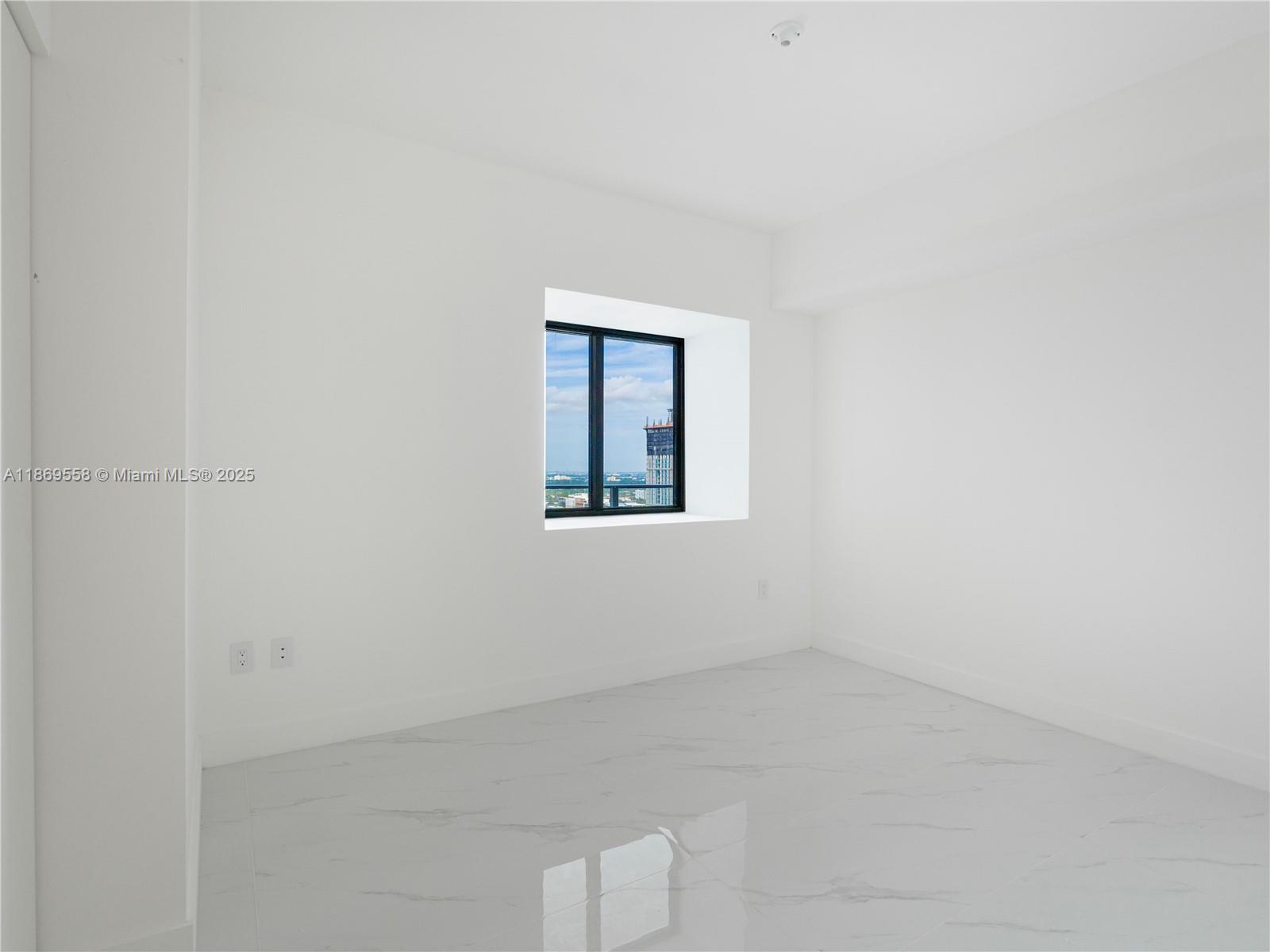 700 Northeast 24th Street, Unit 3606 Miami, FL 33137 - Photo 14 of 28 an empty room with a window