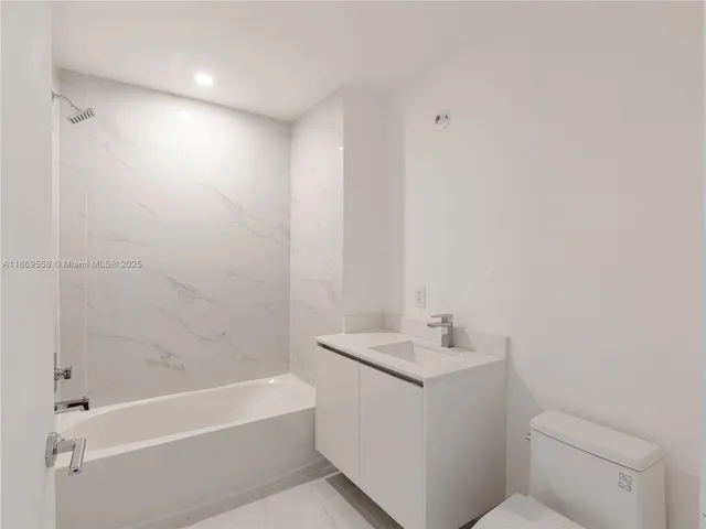 a view of a room that has a white bench in it