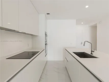 a kitchen with a sink and cabinets