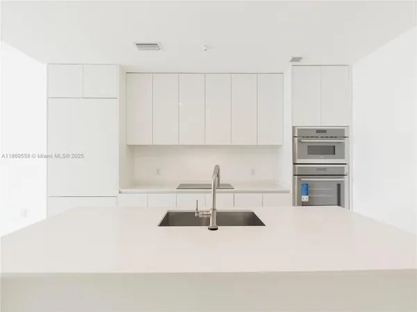 an empty room with large glass door