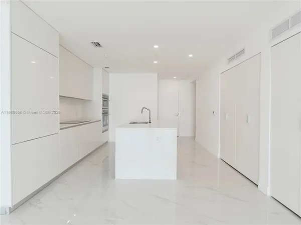 an empty room with a bench and cabinet