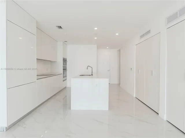 an empty room with a bench and cabinet