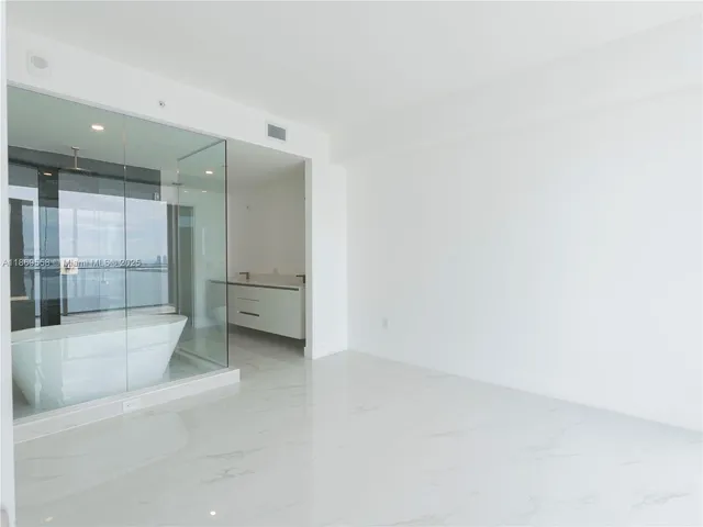 a view of an empty room with a large window