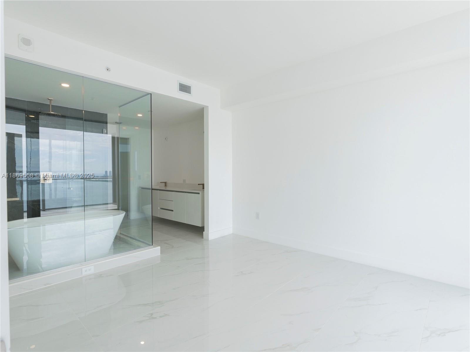700 Northeast 24th Street, Unit 3606 Miami, FL 33137 - Photo 7 of 28 an empty room with large glass door