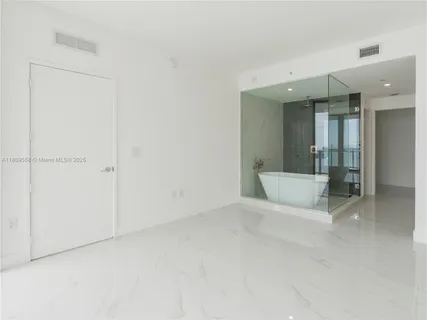 a white bath tub sitting next to a white sink
