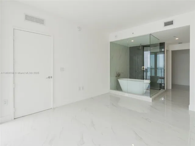 a white bath tub sitting next to a white sink