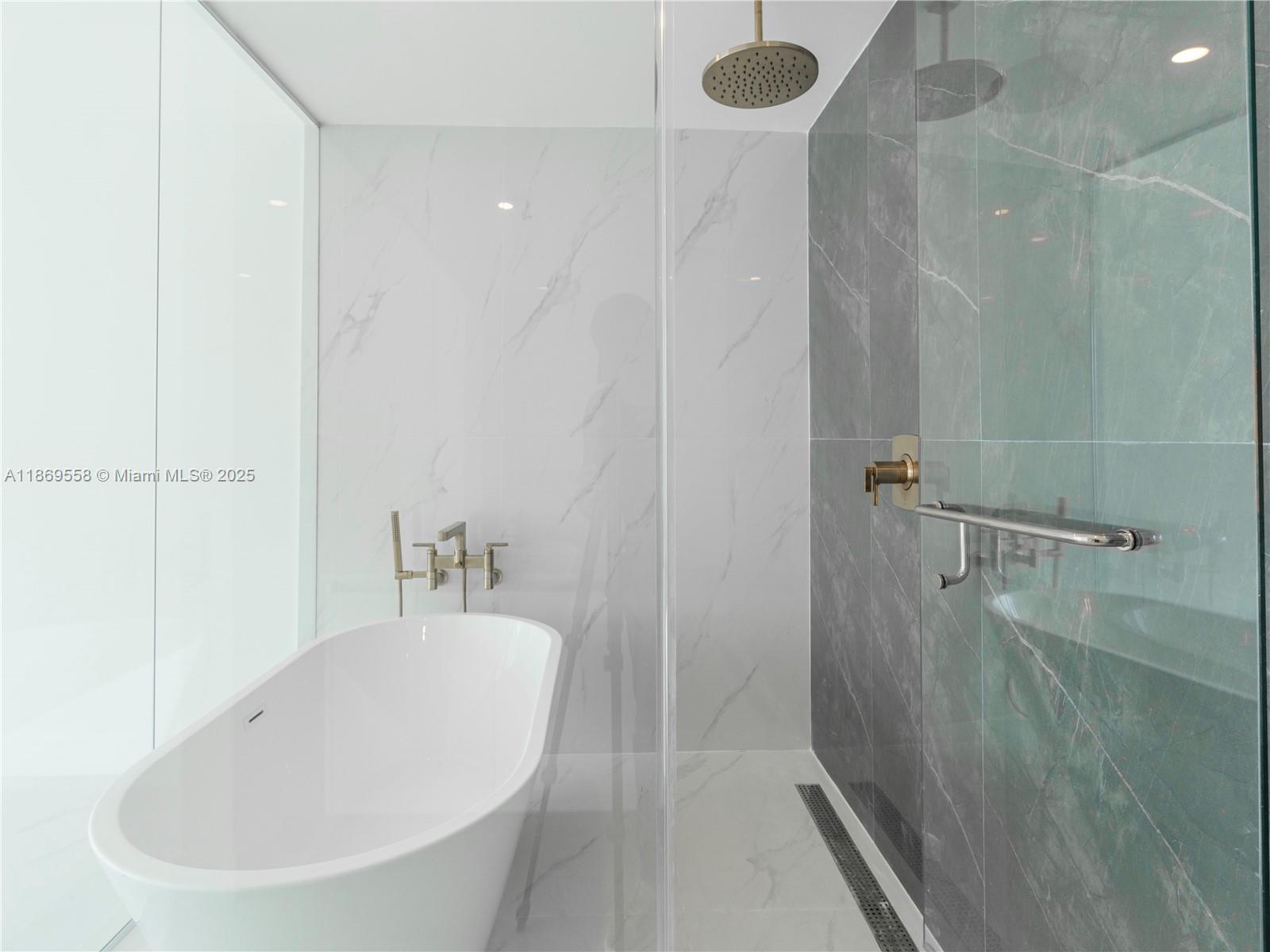 700 Northeast 24th Street, Unit 3606 Miami, FL 33137 - Photo 10 of 28 a white bath tub sitting next to a white sink