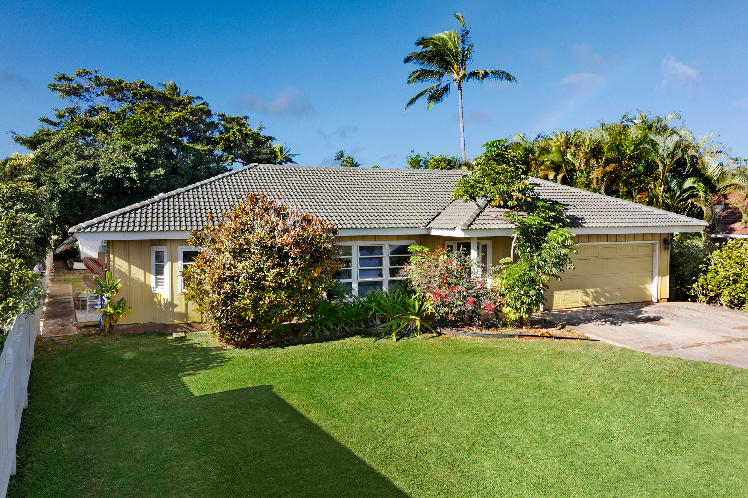 a front view of a house with a garden