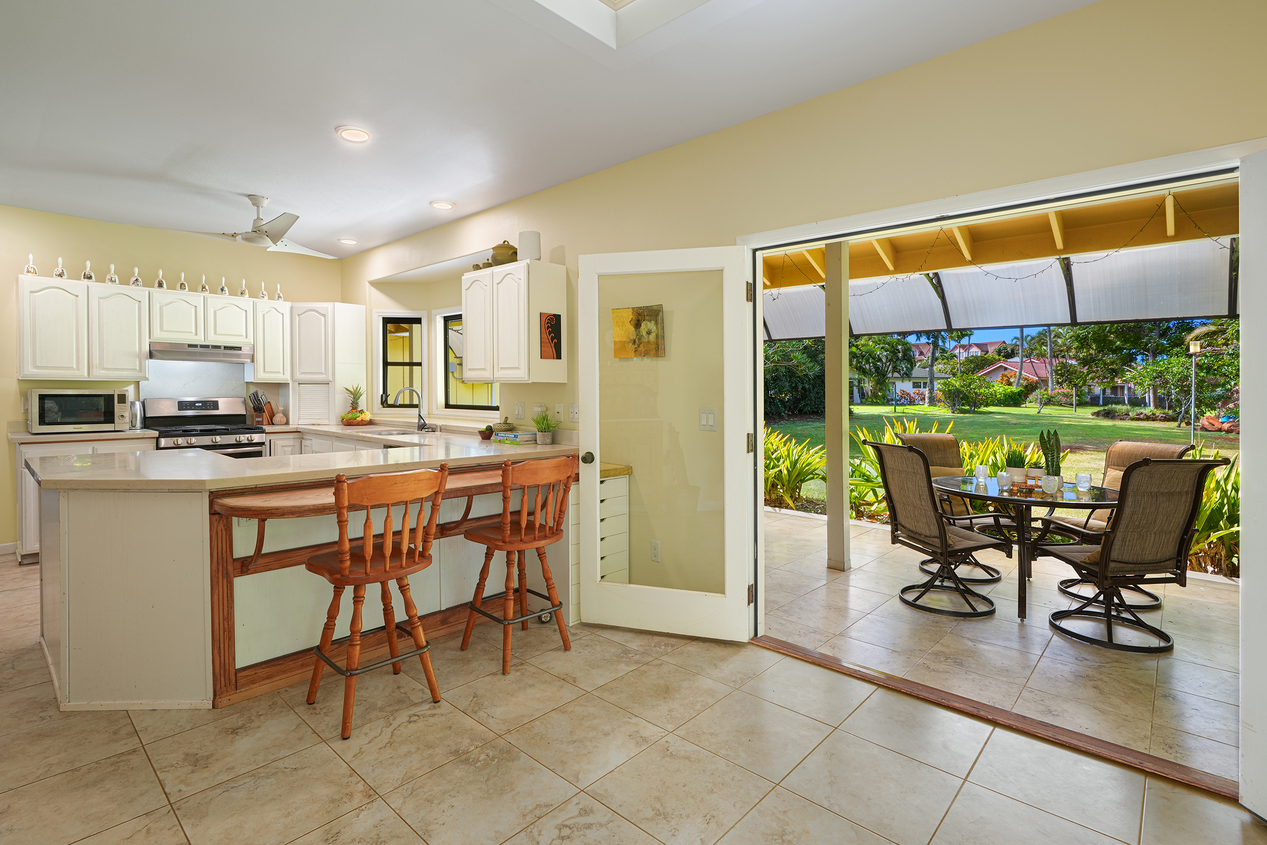 2255 Loke Road Koloa, HI 96756 - Photo 3 of 17 a kitchen with a table chairs and a refrigerator