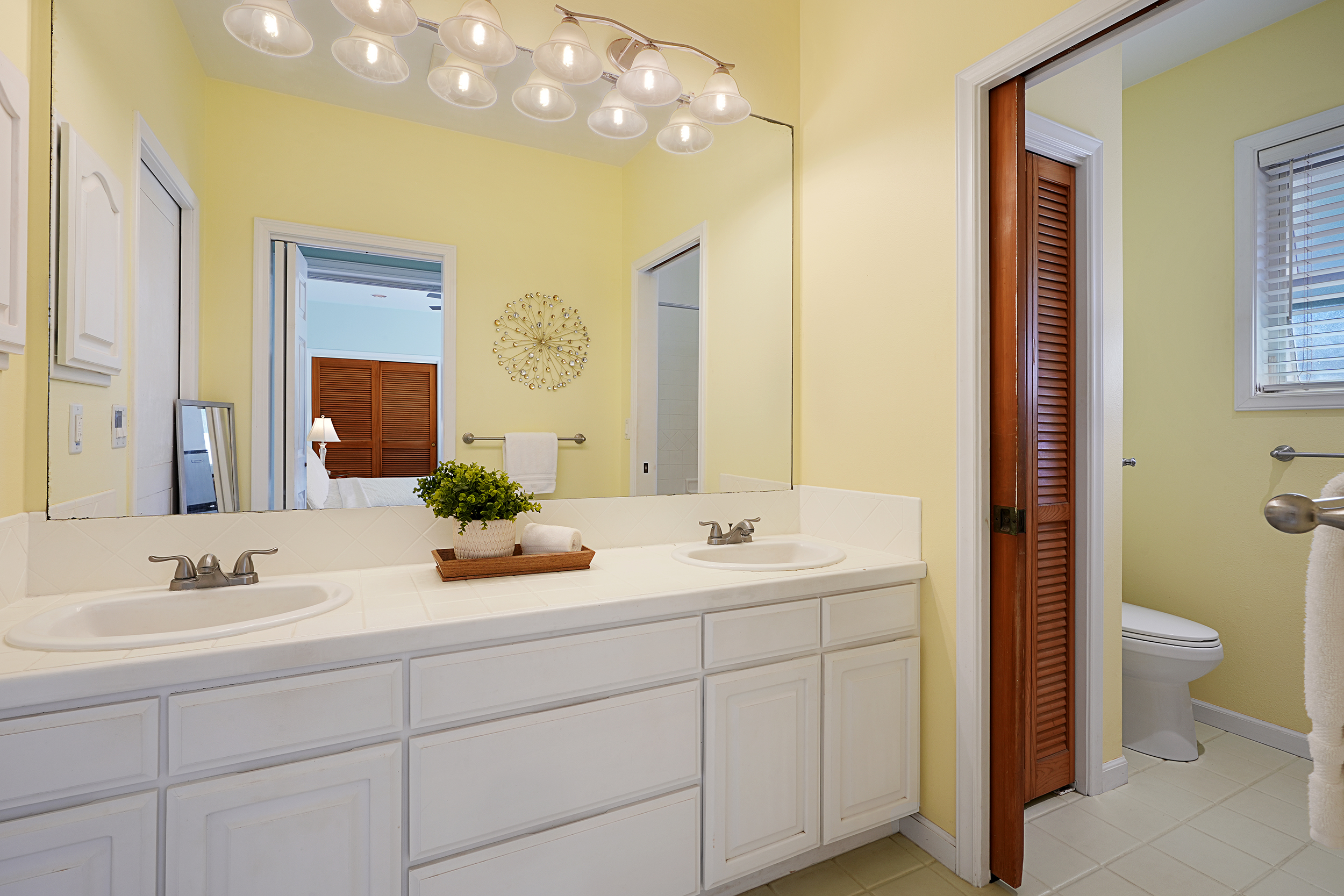 2255 Loke Road Koloa, HI 96756 - Photo 10 of 17 a bathroom with a double vanity sink mirror and toilet