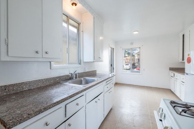 a white refrigerator freezer sitting inside of a kitchen
